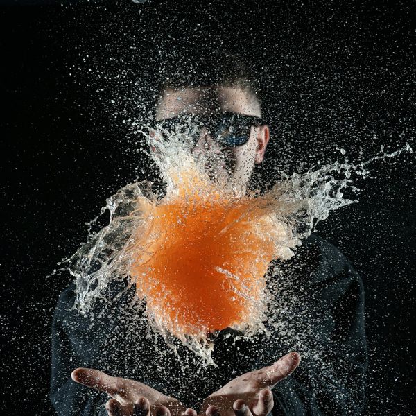 Person in mid-motion, captured with a slow shutter speed to show fluid movement against a dark background.